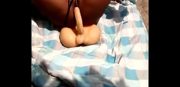  Honey Ebony girl having fun on outdoor  with dildo